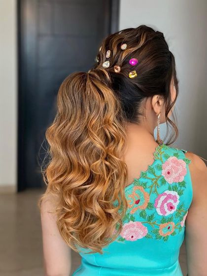 A messy ponytail with colorful stone accessories. This look, taught in my masterclass, is a fun and creative way to style a classic ponytail.