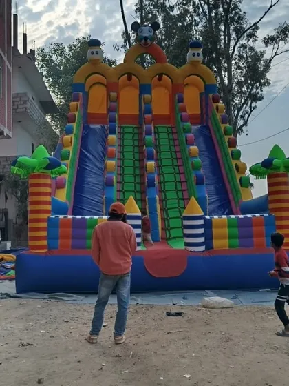 This is a 3-lane Mickey Mouse slide being set up. Even during inflation, you can see how big and colorful it is.