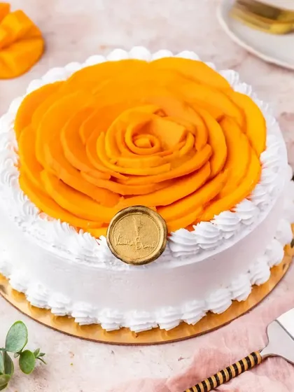 Our Mango Fresh Cream Cake is a light and refreshing summer treat. It's topped with a beautiful rosette of thinly sliced fresh mangoes, making it as beautiful as it is delicious.