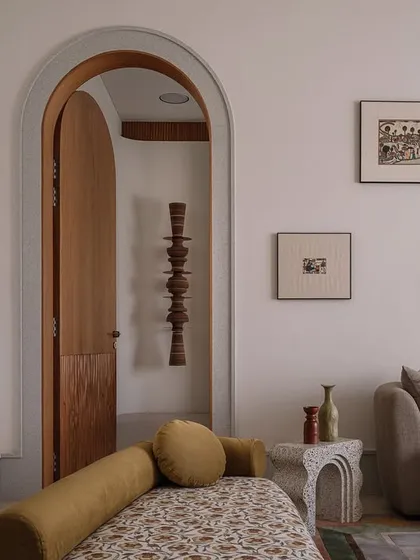 This is the parents' suite at our Rehethaan project. The family room is defined by a serene palette of ivories and ochres, with custom-designed sofas and a patterned chaise lounge creating a comfortable and elegant living space.