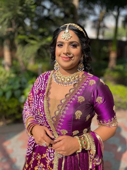Another angle of this lovely purple-toned look. The soft, curly hairstyle adds a touch of romance and balances the vibrant colors of her outfit.