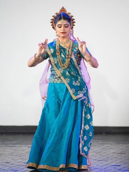 As Radha, every gesture is filled with meaning. This pose, with hands held in a specific mudra, conveys a sense of devotion and surrender, central to the character's relationship with Krishna.