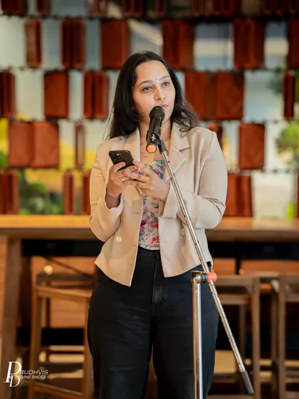 A performer shares her story with a serious and heartfelt expression. Our themed events often bring out deep and personal narratives from our community members.
