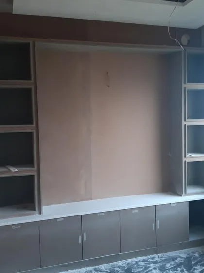 The framework for a large storage and display unit in an office. This work-in-progress shot shows the underlying structure before painting and finishing, highlighting the importance of solid carpentry.