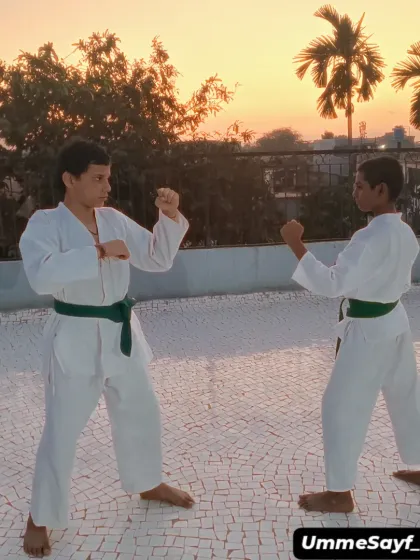Two green belt students practicing their fighting stances against a beautiful sunset. Every session is a new experience and a chance to get better.