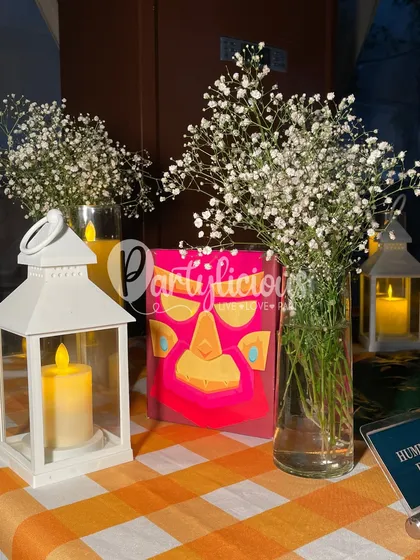 A close-up of the table details from the tribal party, showing how we mix simple elements like baby's breath and lanterns with thematic props.