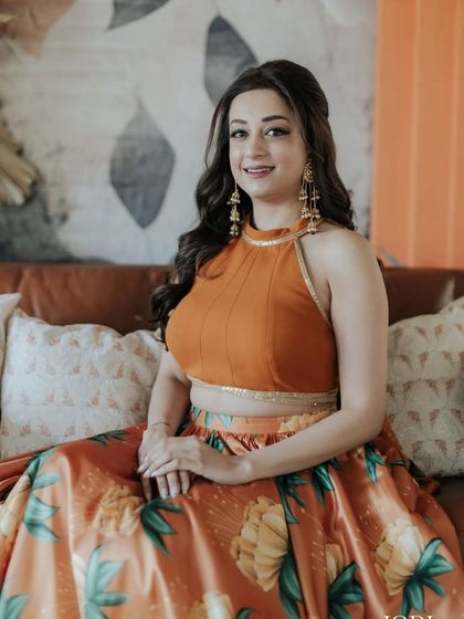 The client looks relaxed and happy, her hair styled in simple, elegant waves.