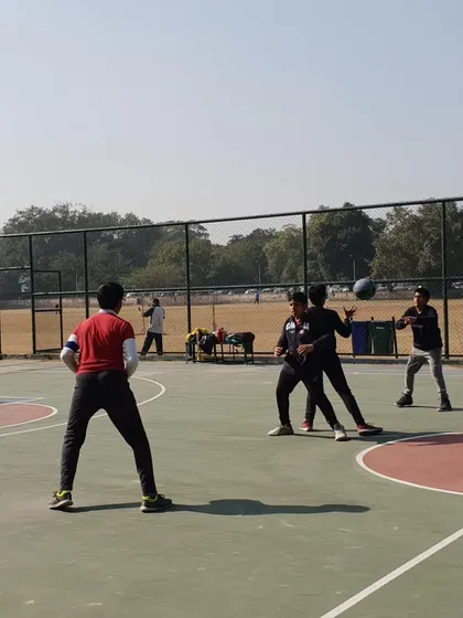 This action shot shows a defensive and offensive drill. We teach players how to maintain proper defensive stance while challenging the ball handler, a key element of smart team defense.
