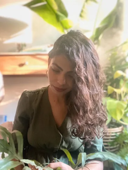 A portrait of me, Deepika, surrounded by the plants that I love. I started ByTheLeaf purely for the love of plants and the sense of peace and grounding they provide.