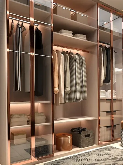 This is where organization meets artistry. We designed this walk-in wardrobe with rose-gold glass and integrated lighting to feel like a personal boutique. Every shirt, accessory, and pair of shoes has its own place, turning the daily routine of getting dressed into a moment of quiet luxury.