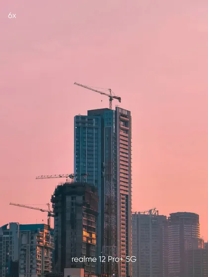 A tight 6x zoom shot of a skyscraper under construction against a pink sky. This mobile photo highlights my skill in using zoom to isolate interesting subjects and create abstract architectural portraits.