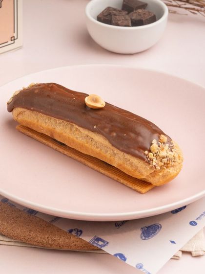 For nut lovers, I offer the Hazelnut Eclair. It's filled with a rich hazelnut pastry cream and glazed with milk chocolate and crushed hazelnuts.