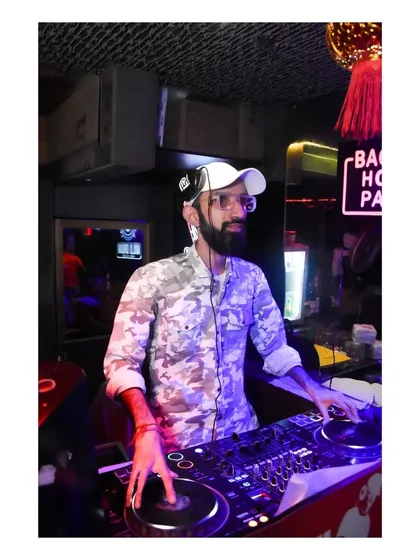 A photo of me scratching on the turntable at a Bacardi House Party. I incorporate various DJ techniques to make my sets more dynamic.