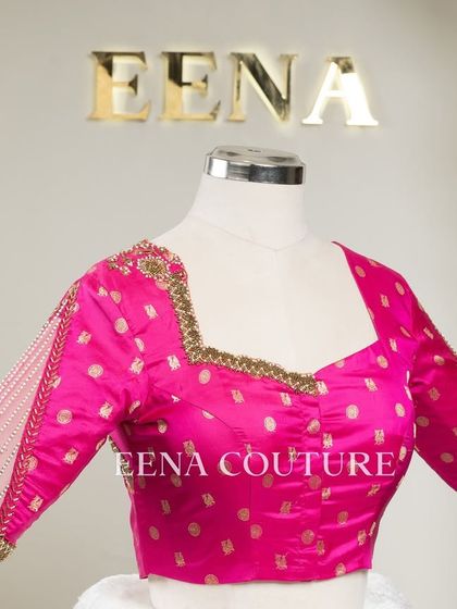 A closer look at the craftsmanship of this pink pure silk blouse. It features intricate handwork with bead detailing on the neckline and delicate net sleeves with linear embroidery for a touch of grace.