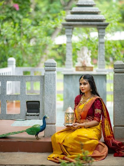The full scene with the peacock and the model creates a picturesque and memorable image.