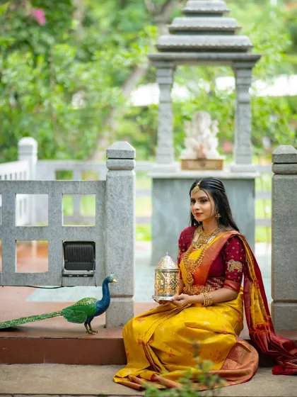 The full scene with the peacock and the model creates a picturesque and memorable image.