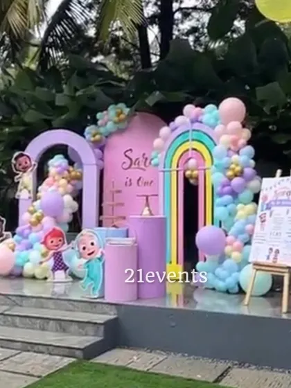 An outdoor Cocomelon setup with beautiful pastel arches and balloons.
