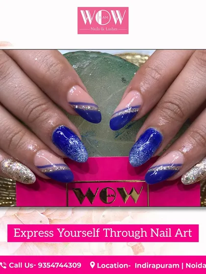 A bold and glamorous design featuring a deep blue polish with silver glitter accents. This look is perfect for making a statement.