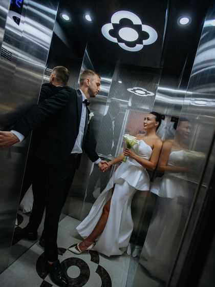 Rising together. An unconventional and stylish wedding portrait inside an elevator, symbolizing the couple's journey upward into their new life together.