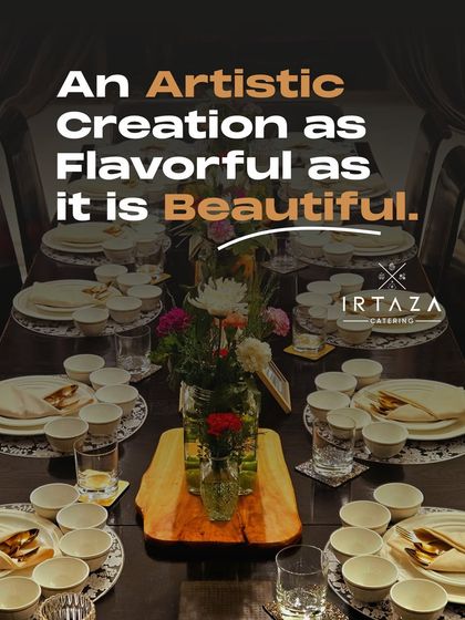 A beautifully set dining table ready for guests. The combination of fresh flowers, classic white dinnerware, and elegant placemats shows our attention to detail.