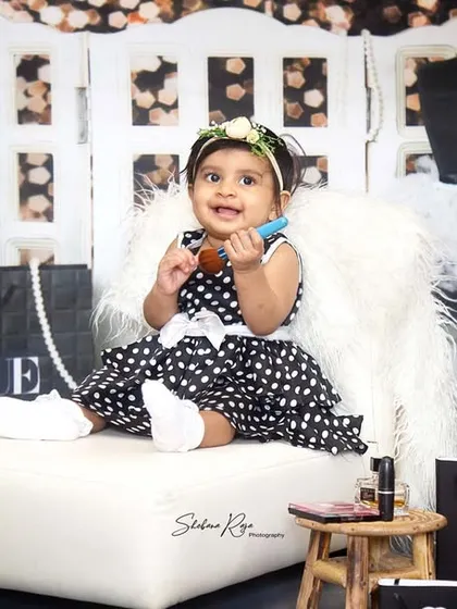 This baby girl is a true beauty in every form. Playing with lipstick and surrounded by glamour, she's a natural in front of the camera.