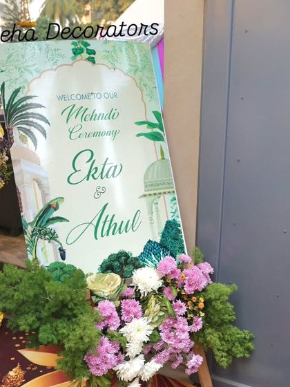 A personalized welcome sets the tone for a beautiful Mehendi ceremony. We design custom signage like this, framed with fresh flowers that match the event's color palette and theme.