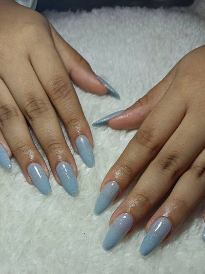 A simple and clean set of long, coffin-shaped extensions in a beautiful dusty blue color with a hint of shimmer. This is a great choice for a chic, minimal look.