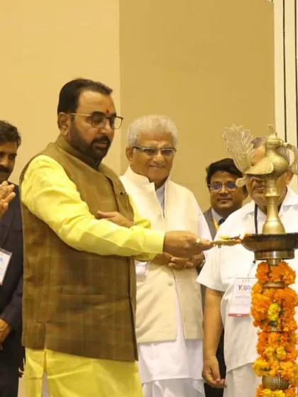 Participating in the traditional lamp lighting ceremony to inaugurate the Yoga Mahotsav event in Delhi.