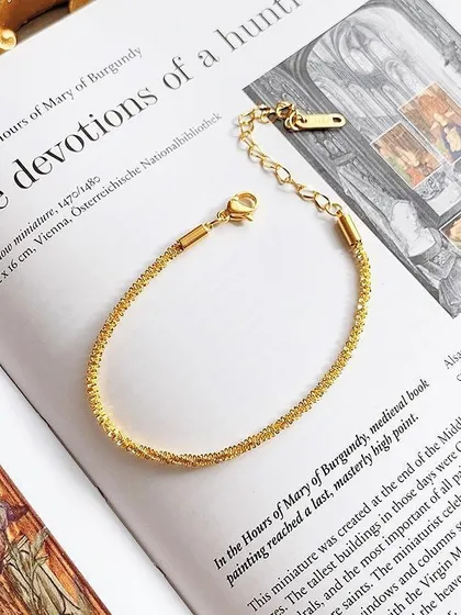 A close-up product shot of my shimmering gold-tone bracelet, showing the adjustable clasp and high-quality stainless steel material.