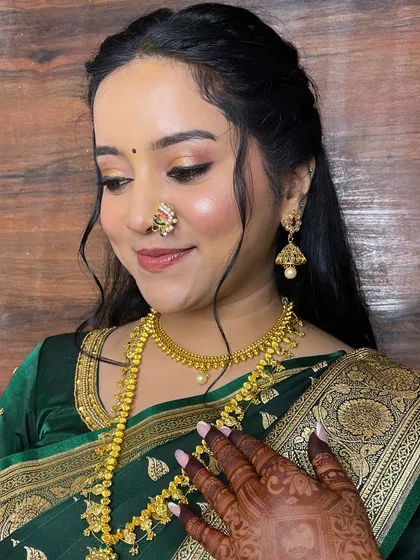 This angle highlights the delicate jewelry and the flawless, glowing skin.