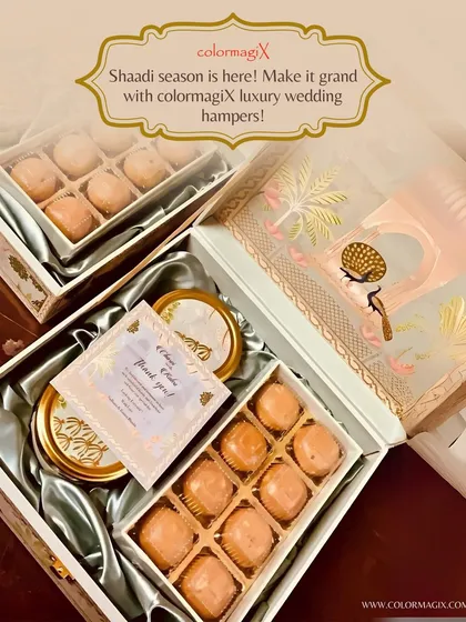 Make it grand with our luxury wedding hampers. This image highlights a custom "Thank You" card placed inside a beautiful box of laddus, adding a personal touch to your wedding favors.