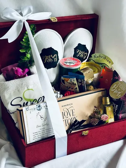 The ultimate bridal hamper, curated to pamper the bride-to-be. This luxurious red velvet keepsake box is filled with personalized slippers, a custom towel, gourmet chocolates, and premium skincare, making it the perfect gift for her big day.