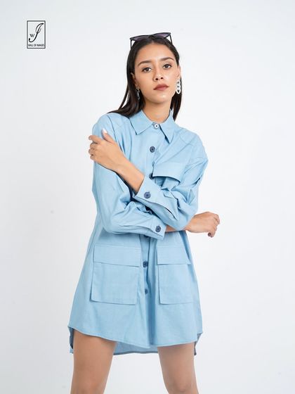 A front-facing shot that clearly displays the pocket details and button-down front of the shirt dress.