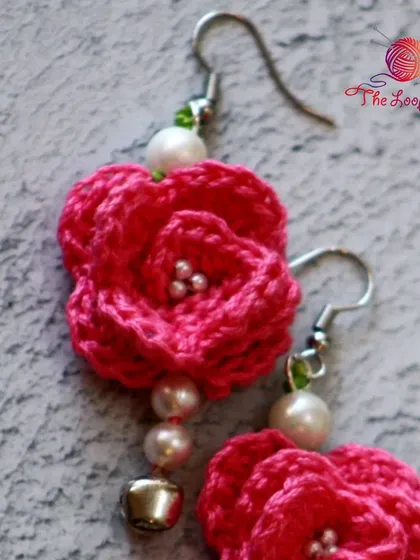 A detailed view of the layered petals on my pink rose crochet earrings.