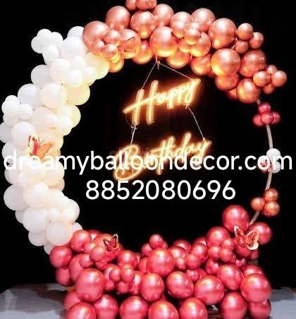 A stunning two-tone balloon ring in white and metallic red. The 'Happy Birthday' neon sign and butterfly accents add a touch of elegance to this modern design.