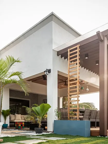 This is a perfect example of how we can transform an open area into a complete outdoor living room. With a sturdy pergola for shade, comfortable seating for lounging, and lush greenery, this has become the family's favorite summer spot.