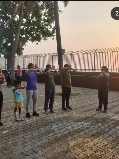 An instructor leads a group of students through warm-up exercises at sunset. We emphasize physical preparedness before every archery session.