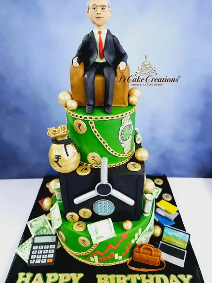 A closer view of the corporate cake, showing details like edible money, a luxury watch, and a briefcase.
