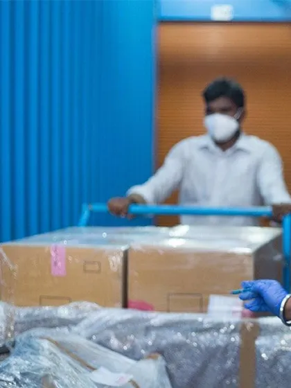 Our trained staff carefully handle your business goods. Here, a team member uses a trolley to safely transport boxes within the facility, demonstrating our commitment to protecting your items at every step.