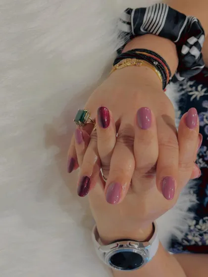 This client's hands are beautifully accessorized, and her mauve and berry manicure is the perfect complement to her style.