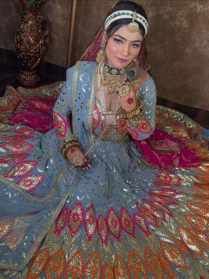 A full view of the stunning multi-colored lehenga, showing how the intricate embroidery and mirror work catch the light. This is a perfect choice for a Mehendi or Sangeet ceremony.