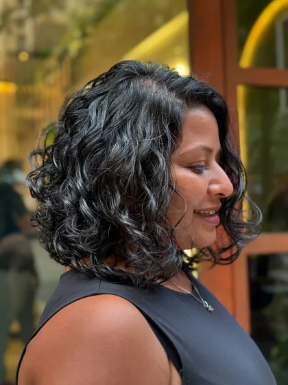 A classy curly bob is always a good idea. This timeless haircut is perfect for adding shape and volume, creating a chic and easy-to-manage style for wavy and curly hair.
