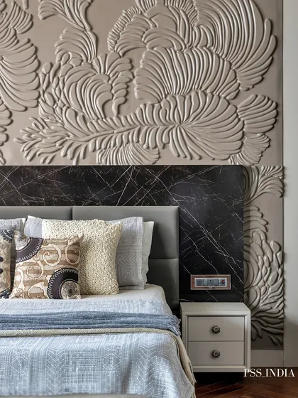 Textural layering is at the heart of my work. This close-up shows how a sculptural, hand-finished wall treatment behind a marble headboard can add immense depth and artistry to a bedroom, turning a simple wall into a focal point.