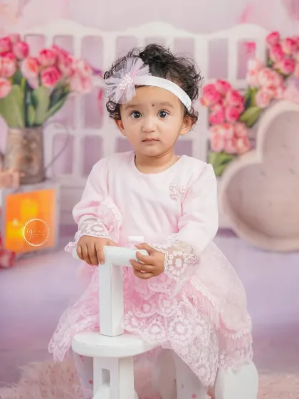 A lovely close-up portrait on the tricycle, highlighting her beautiful curly hair and sweet expression.