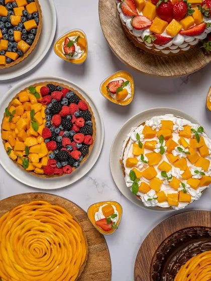 It’s that magical time of year when mangoes steal the spotlight. Here’s a beautiful spread of my mango and berry desserts, including my half-and-half tart and mango cream cakes.