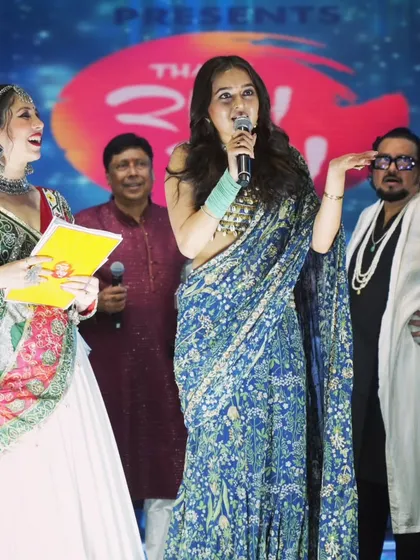 A candid moment of laughter on stage with Tejasswi Prakash during the Navratri celebrations.
