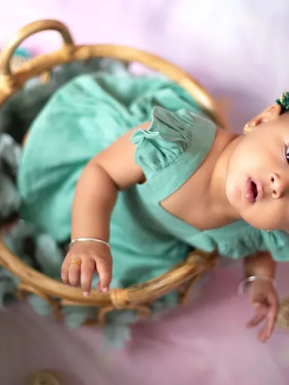 An artistic overhead shot of the baby in the hot air balloon basket, creating a unique and memorable portrait.