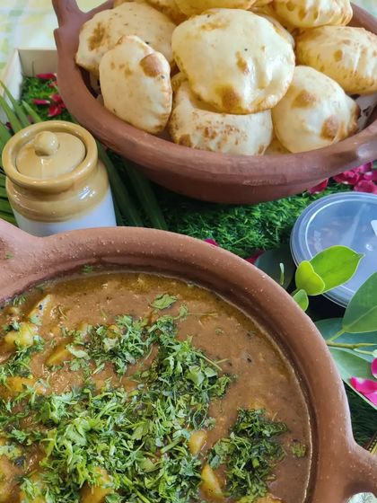 A rustic presentation of our Kachori Sabzi, a special dish we prepare for the Gangaur Teej festival. The meal is served in earthenware to maintain its authentic taste and warmth.