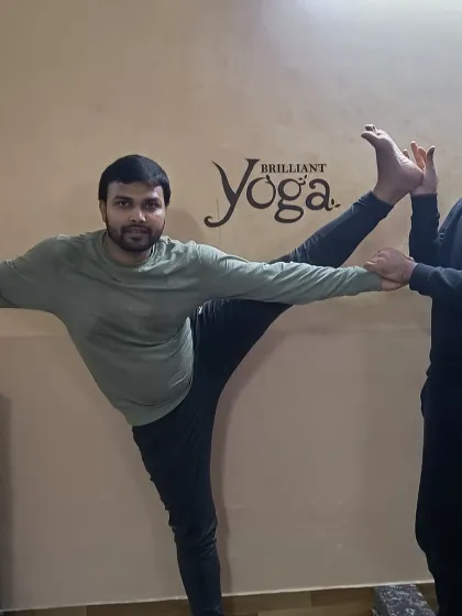 A student receives a gentle adjustment in Trivikramasana to open the hips and hamstrings correctly. Learning these adjustments is a vital skill for aspiring yoga teachers.