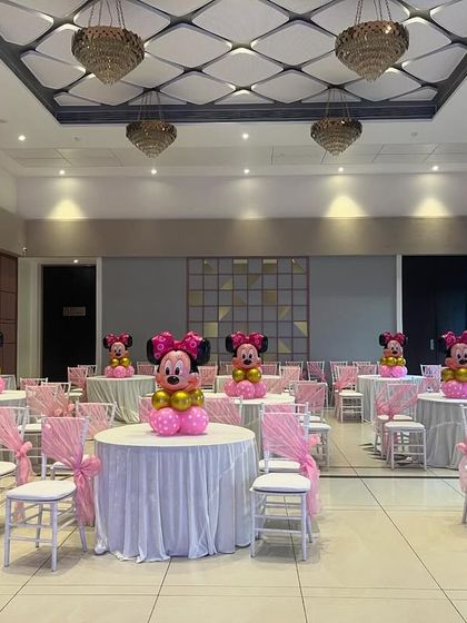 I also handle guest seating arrangements to match the theme. For this Minnie Mouse party, each table had a custom centerpiece and chairs decorated with pink sashes.